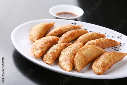 mandu twigim Fried Dumplings on plate