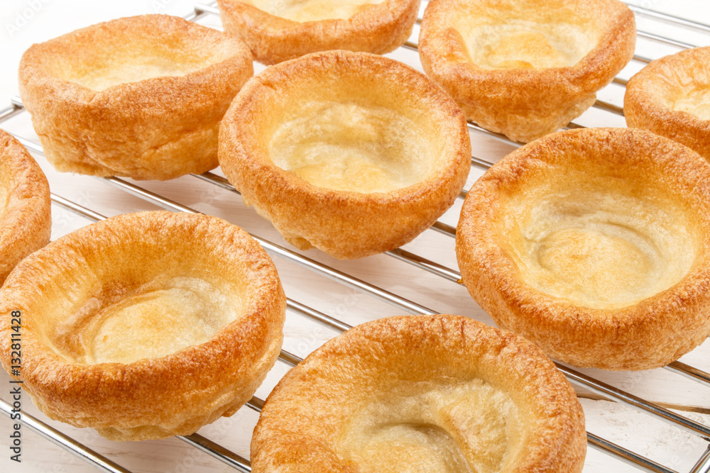 freshly baked yorkshire pudding on a cooling rack