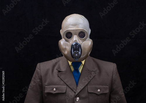 studio portrait of a soldier in a gas mask isolated on a black background