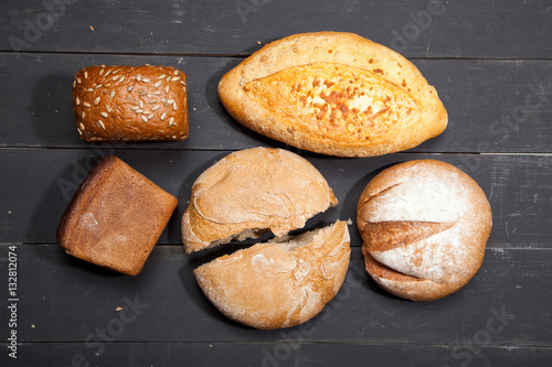 Homemade bread on a black wooden background