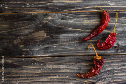 Red pepper on a wooden background in rustic style
