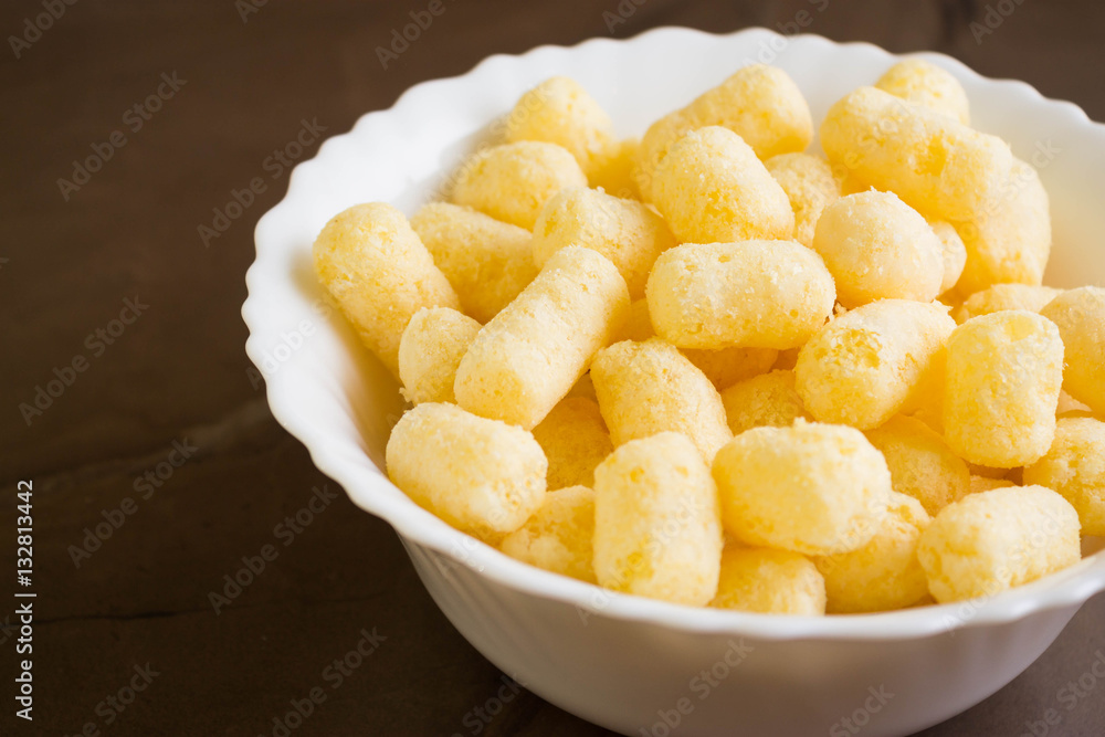 Sweet corn sticks in a white bowl. Tasty dessert. Sweet corn sticks in a white bowl. Tasty dessert.