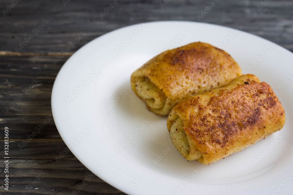 Fried pancakes with meat on a white plate Fried pancakes with meat on a white plate