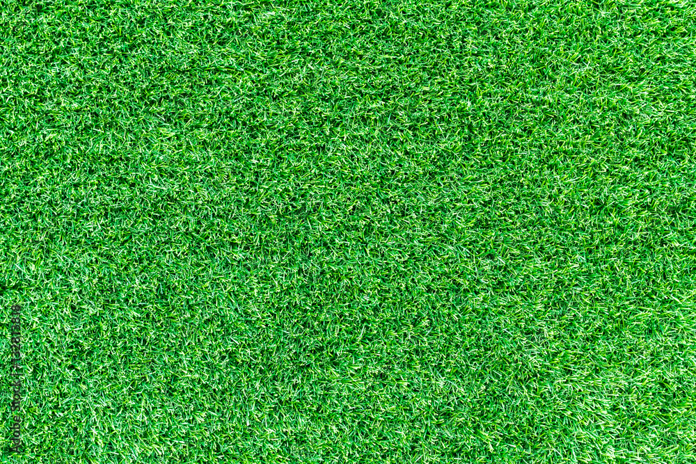 Obraz premium Green grass texture, grass background for design with copy space for text or image. Top view of artificial green grass for golf course and soccer field.