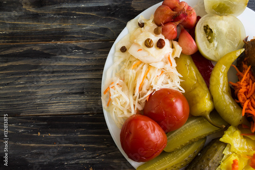 Pickled vegetables on a white plate in a rustic style