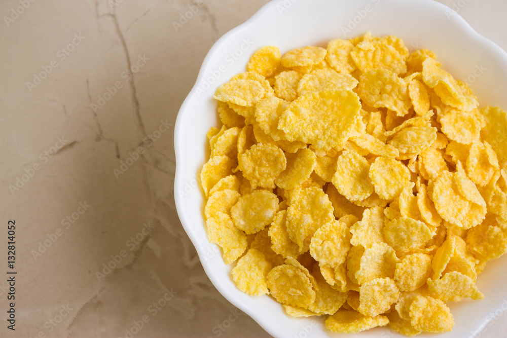 Cornflakes in a white bowl. A hearty and delicious breakfast. Cornflakes in a white bowl. A hearty and delicious breakfast.
