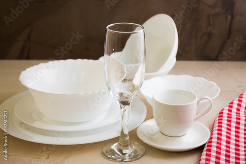 Various white dishware on a marble background