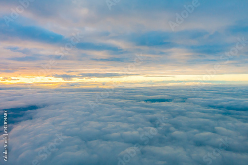 Sunrise above clouds from airplane window .