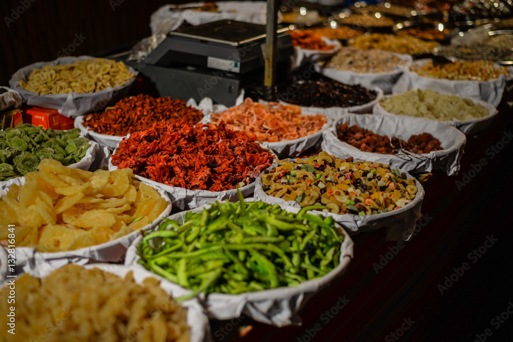 Colorful variety dry fruits and nuts in the street shop vibrant background