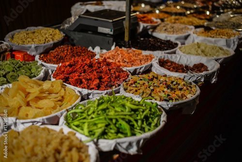 Colorful variety dry fruits and nuts in the street shop vibrant background