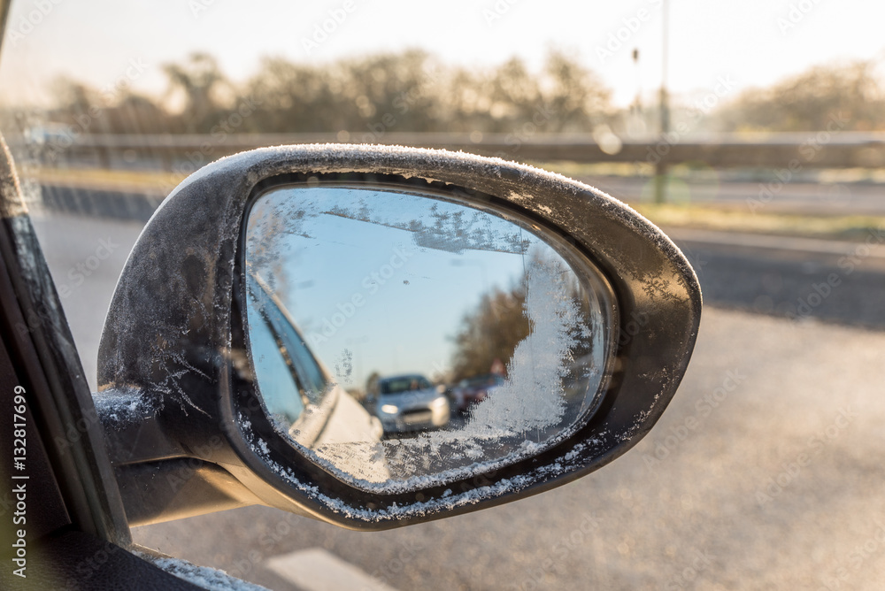 Back view through frozen car wing mirror on motorway Back view through frozen car wing mirror on motorway