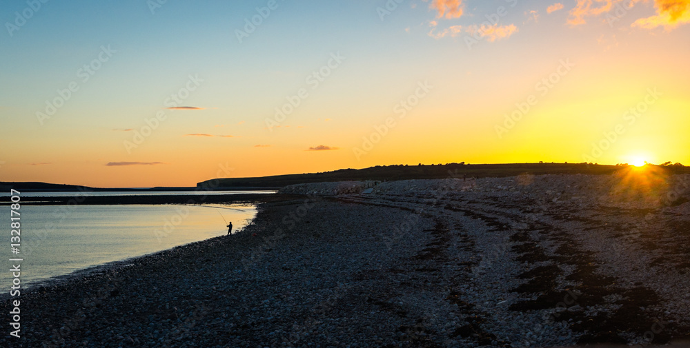 evening beach fisherman sunset