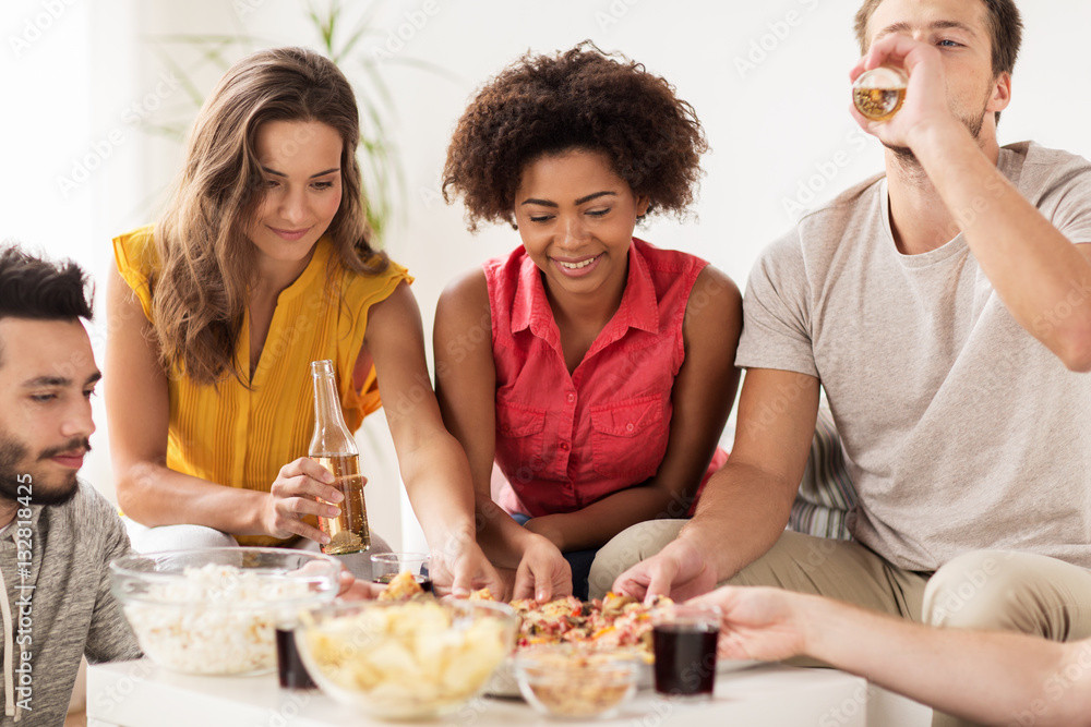 happy friends with drinks eating pizza at home happy friends with drinks eating pizza at home