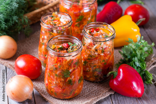 Vegetable salad in glass jar on wooden table