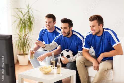 friends or football fans watching soccer at home © Syda Productions