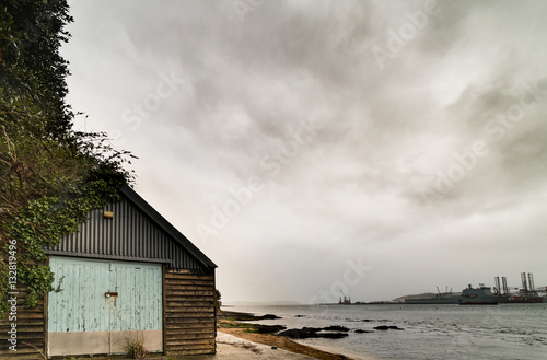 old boathouse with falmouth docks in background
