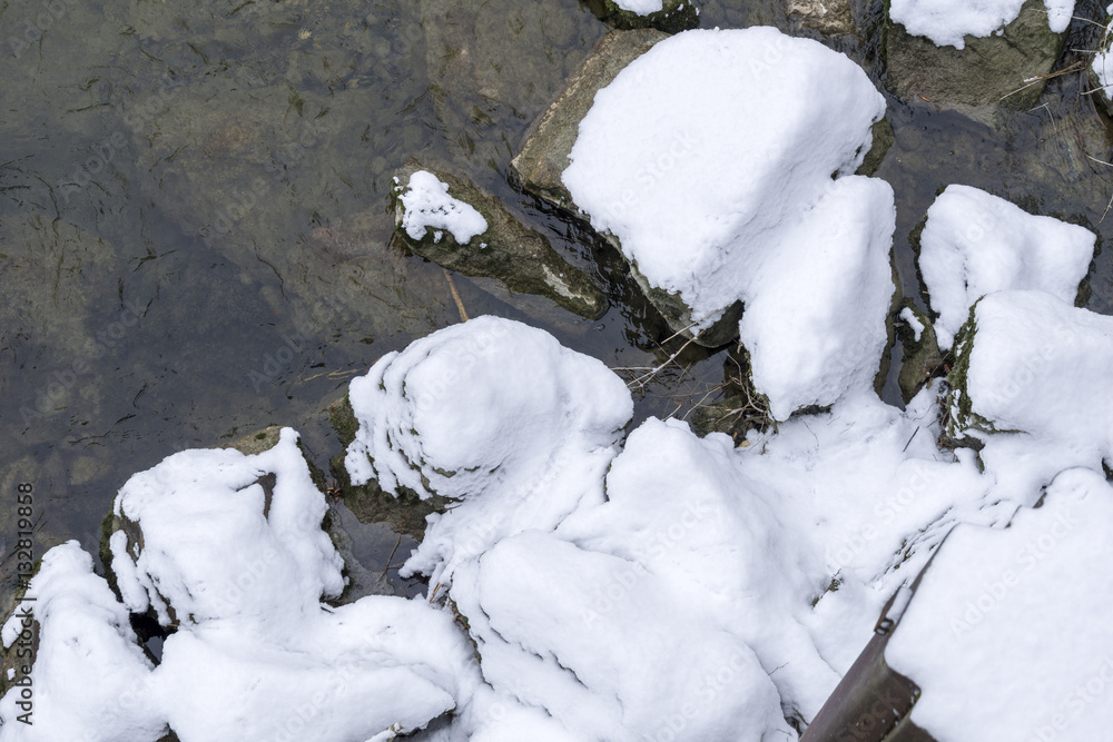 Schnee auf Steinen im Fluss Schnee auf Steinen im Fluss