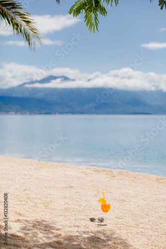 orange tropical cocktail on beach