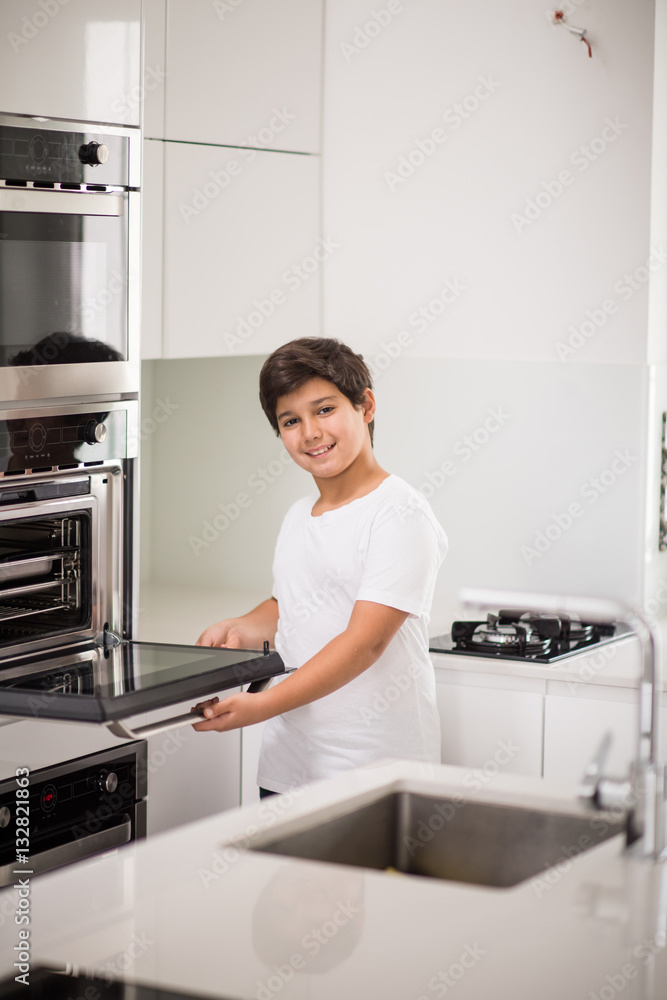 A boy standing in new modern kitchen A boy standing in new modern kitchen