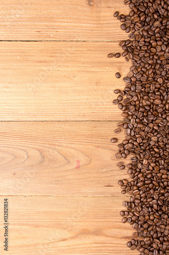 Coffee background. Heap roasted coffee beans spread over on tabl