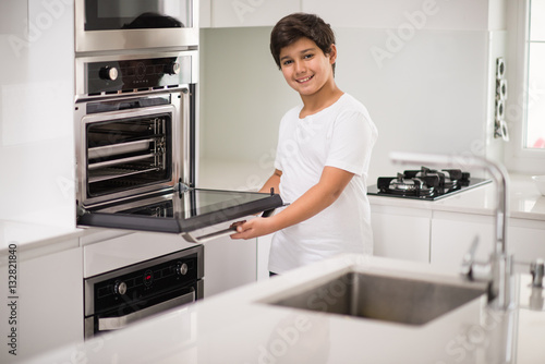 A boy standing in new modern kitchen