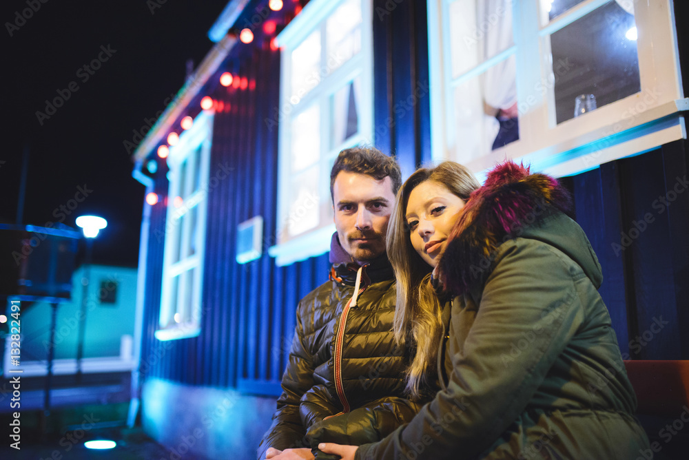 Man and Woman Sitting on Bench at Night Man and Woman Sitting on Bench at Night