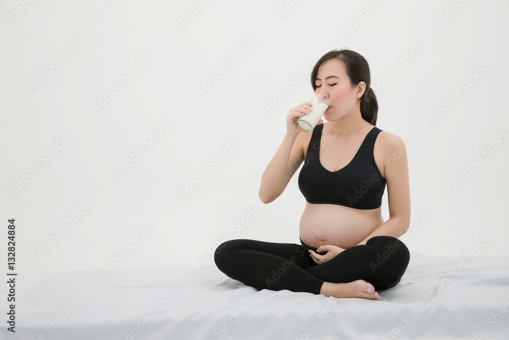 Pregnant Woman Sitting and Drinking Milk Pregnant Woman Sitting and Drinking Milk