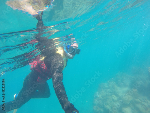 Underwater scuba diving selfie in Great Barrier Reef, Australia