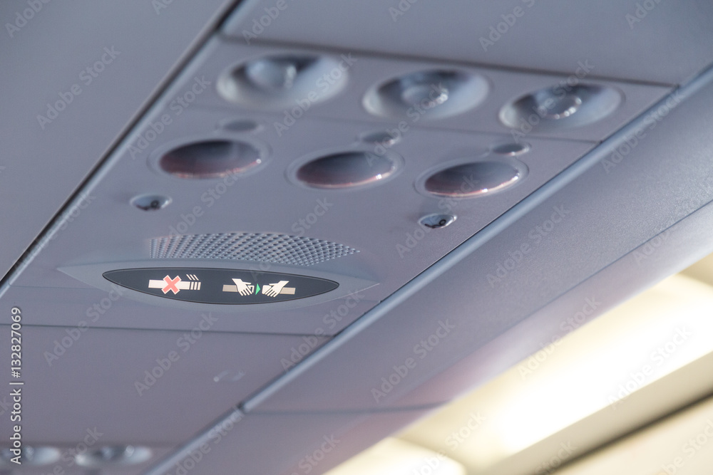 Plane interior No Smoking and Buckle Seat-Belt signage Plane interior No Smoking and Buckle Seat-Belt signage