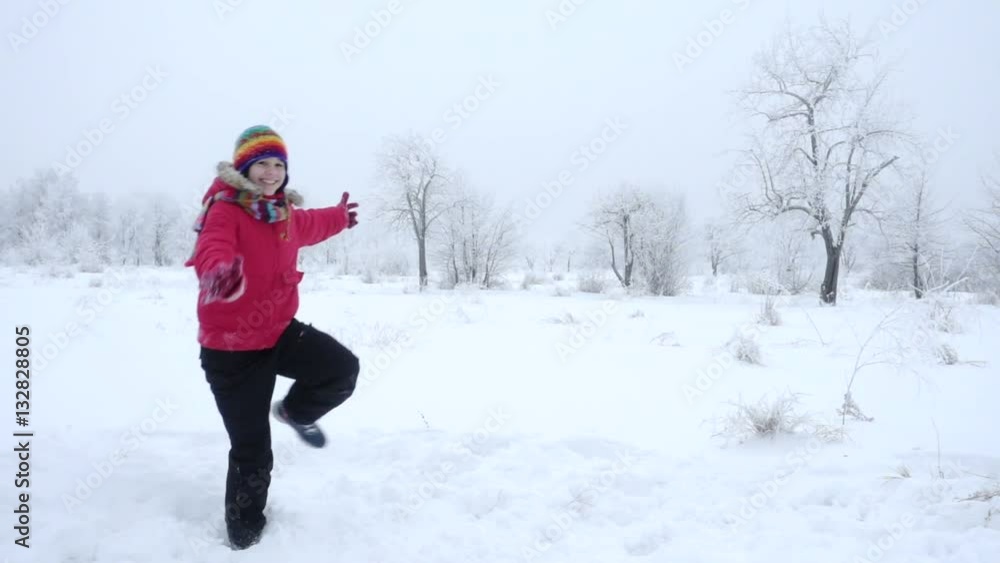 Two kids running together on winter landscape, slow motion Two kids running together on winter landscape, slow motion