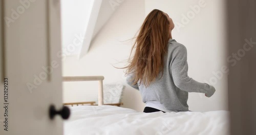 Young adult female getting up in the morning