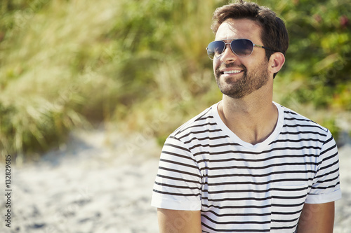 Shades guy smiling and wearing striped t-shirt