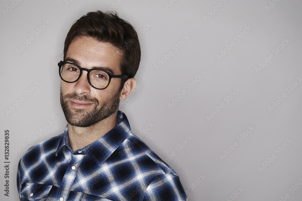 Portrait of man in checked shirt, smiling Portrait of man in checked shirt, smiling