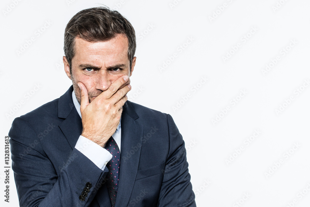 frowning unhappy businessman thinking, expressing corporate doubts and concerns frowning unhappy businessman thinking, expressing corporate doubts and concerns