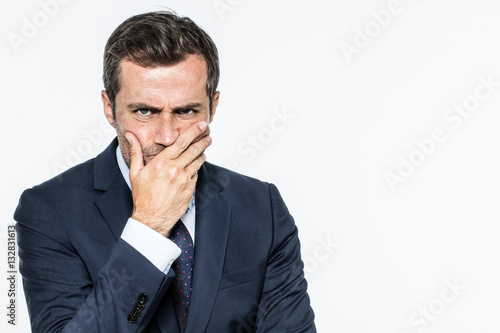 frowning unhappy businessman thinking, expressing corporate doubts and concerns