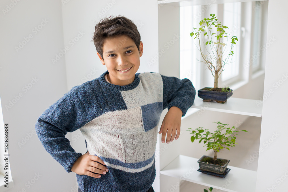 Kid taking care of plants and flowers at home Kid taking care of plants and flowers at home