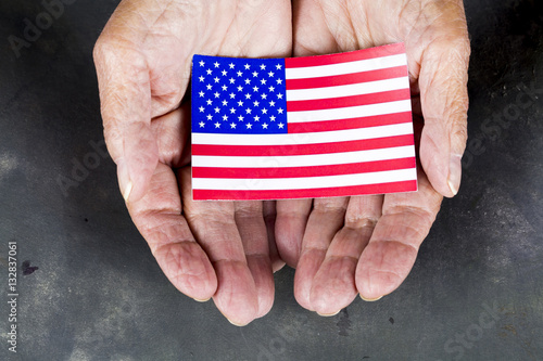 Hands Holding American Flag photo