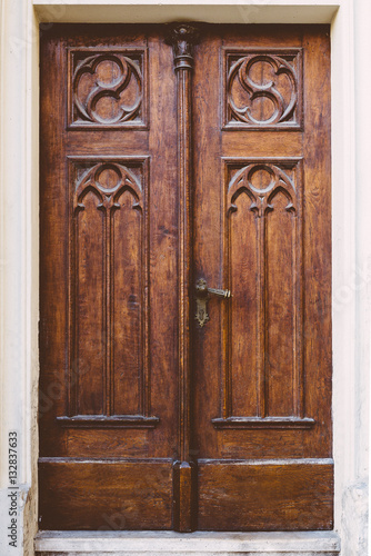 Old wooden door with metal handle © AH! Studio