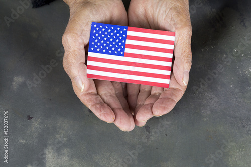 Hands Holding American Flag photo