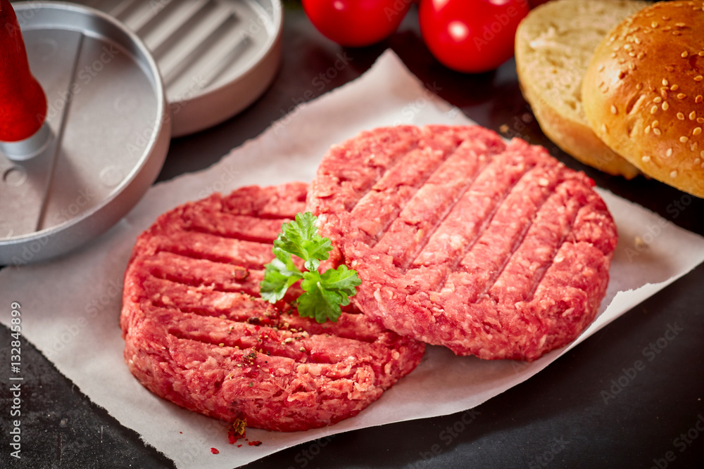 Raw Hamburger Patties Topped with Fresh Parsley Raw Hamburger Patties Topped with Fresh Parsley
