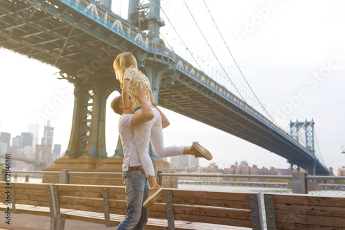 Young Couple in Love Visiting Brooklyn Bridge . New York City US