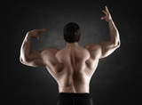 Close up of sports man's muscular back isolated