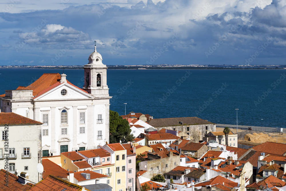 View of the Alfama Neighbourhood in Lisbon with the Tagus River in the background in Portugal