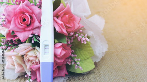 Positive pregnancy test with rose for love