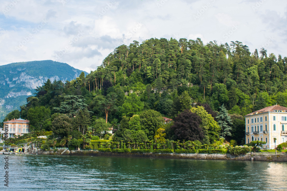 View on coast line of Lake Como, Italy, Lombardy region. Italian landscape, with Mountain trees and buildings on the shore