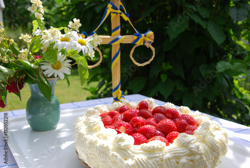 Cake with strawberries and cream at a table