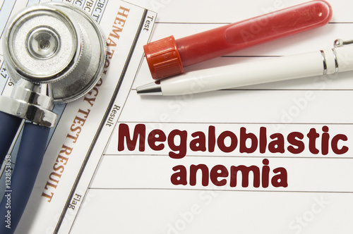 Diagnosis of Megaloblastic Anemia. Test tubes or bottles for blood, stethoscope and laboratory hematology analysis surrounded by text title of diagnosis of Megaloblastic Anemia lie in doctor workplace photo