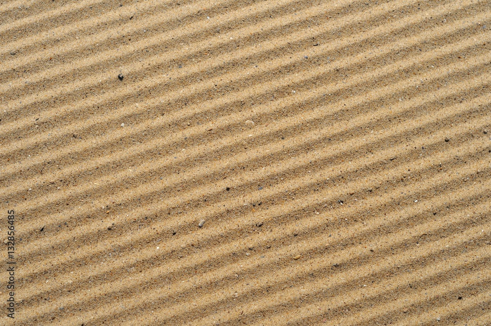 stripes on the sea sand after cleaning the beach from debris. stripes on the sea sand after cleaning the beach from debris.