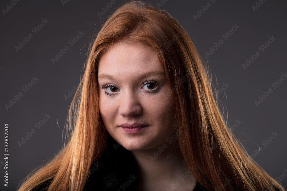 Naklejka premium red haired woman on a black fur coat