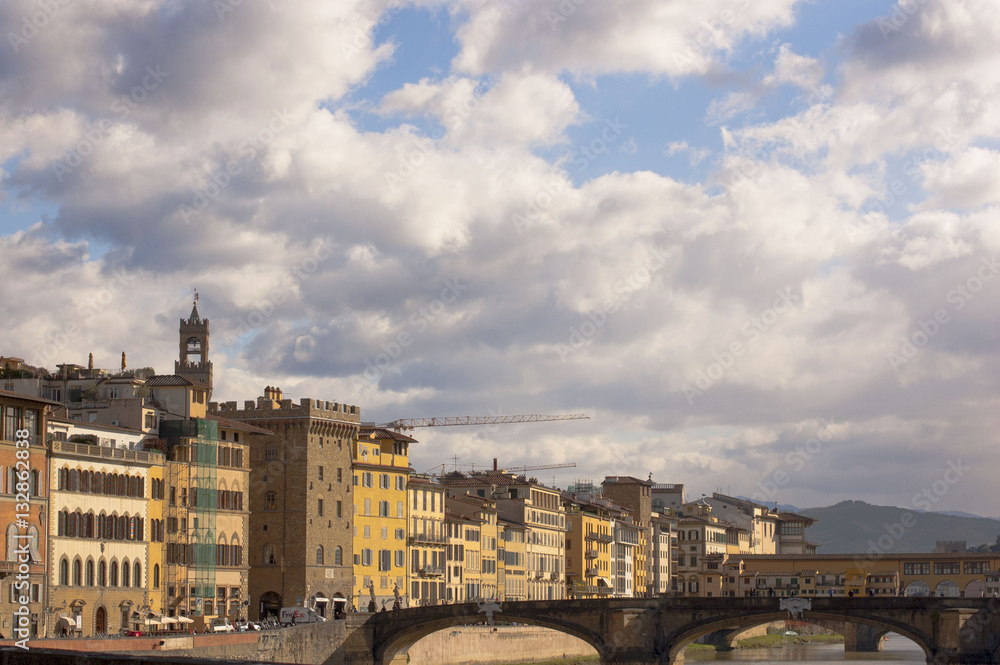 Arno's quai in Florence with yellow buildings and bridges